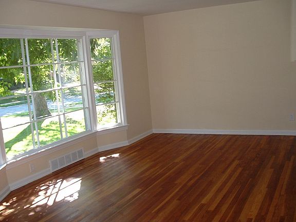 Bay window in living room with beautiful hardwood flooring.