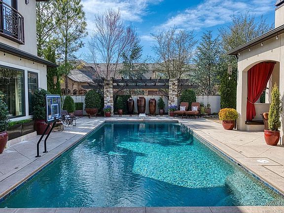 Pool with covered patios, hot tub, dining area, drink cooler, sink and grill