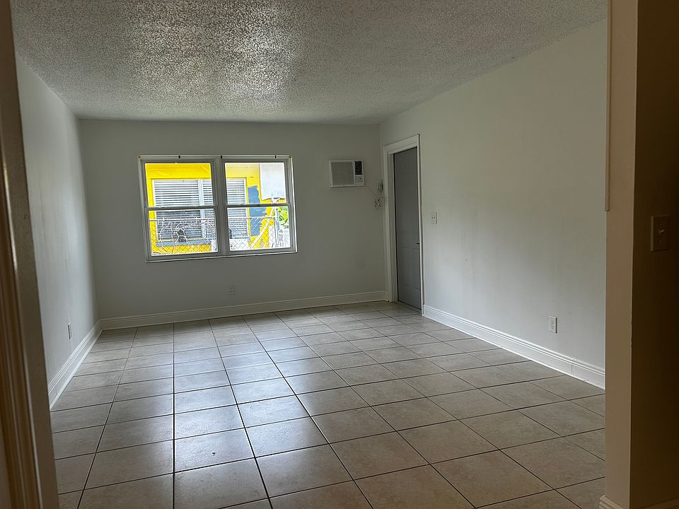 Standing in the kitchen looking towards the living room. Blinds will be installed.