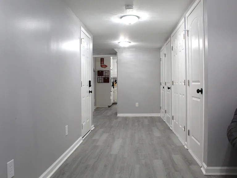 The garage entry is on the left of the hallway. The apartment has all new flooring throughout.