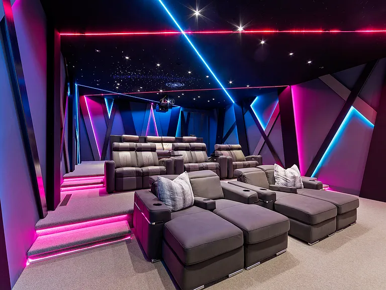 Custom 25 seat home theater with floor to ceiling screen, surround sound, custom lighting