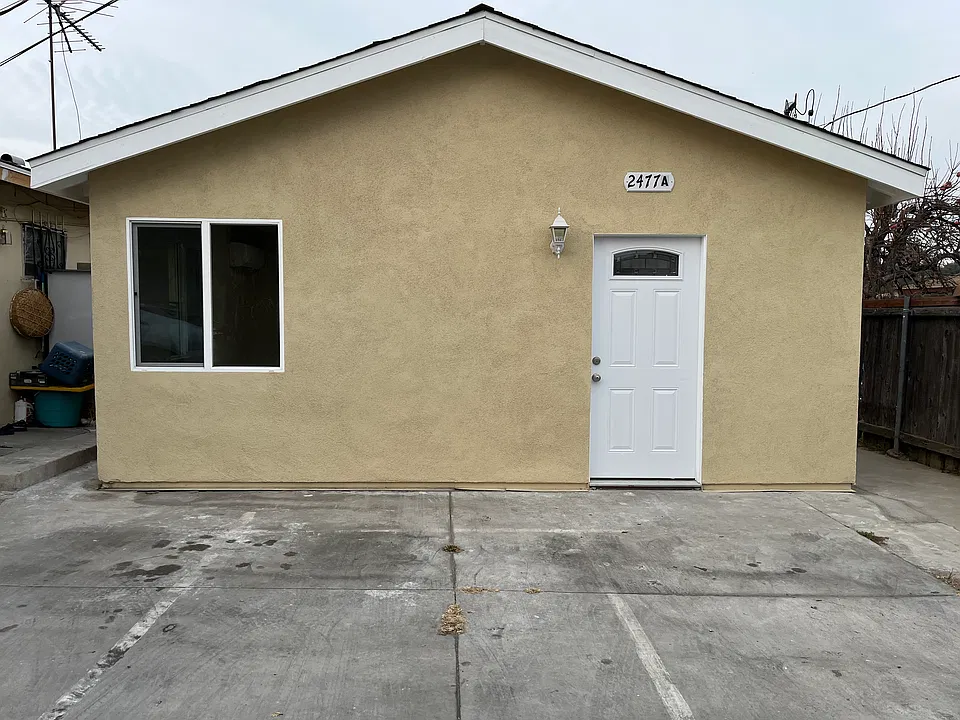 Front of unit with one designated outdoor parking spot