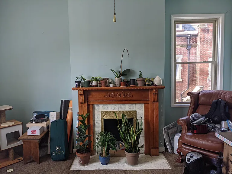 Bedroom #3 on second floor with decorative fireplace and mantle. Currently being used as an office.