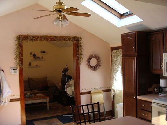 Cathedral ceiling, skylight and ceiling fan in kitchen
