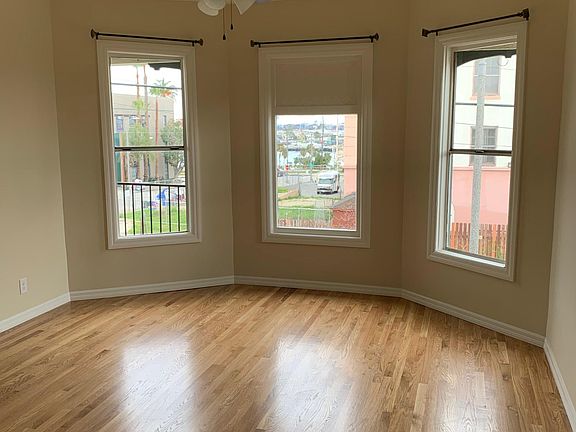 Large Octagonal Shaped Living Room with Bay Windows facing San Pedro Harbor and Newly Installed Hardwood Floors