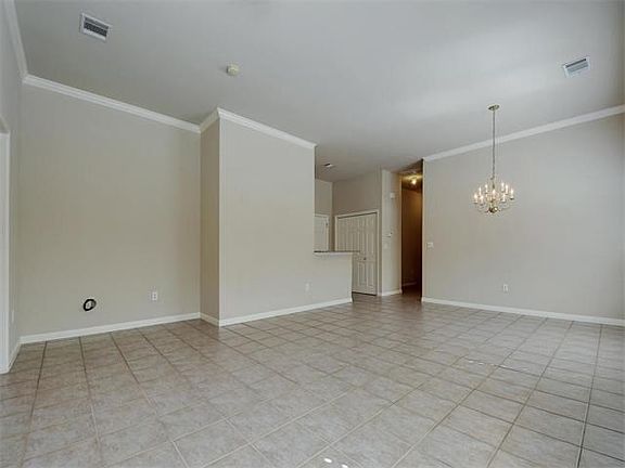 Dining and Living area features crown moulding and neutral wall color finishes.