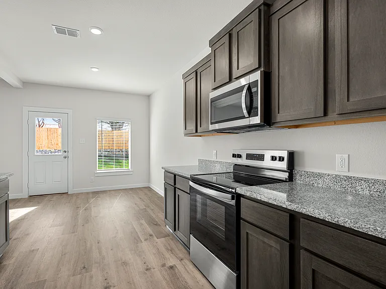 The kitchen has sprawling granite countertops.