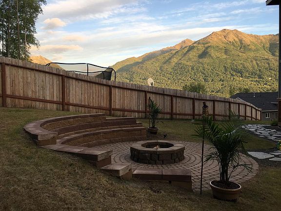 Custom amphitheater style seating fire pit. Amazing mountain & glacier views in Eagle River valley.
