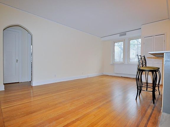 Large Living Room, with refinished hardwood floors, opens to the kitchen.