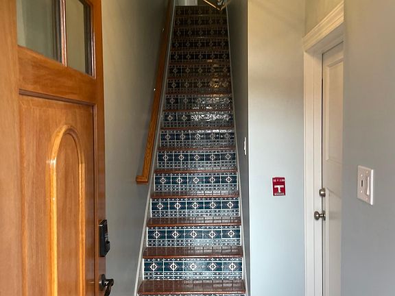 The entrance is spectacular starting with its beautiful door and colorful staircaseThi