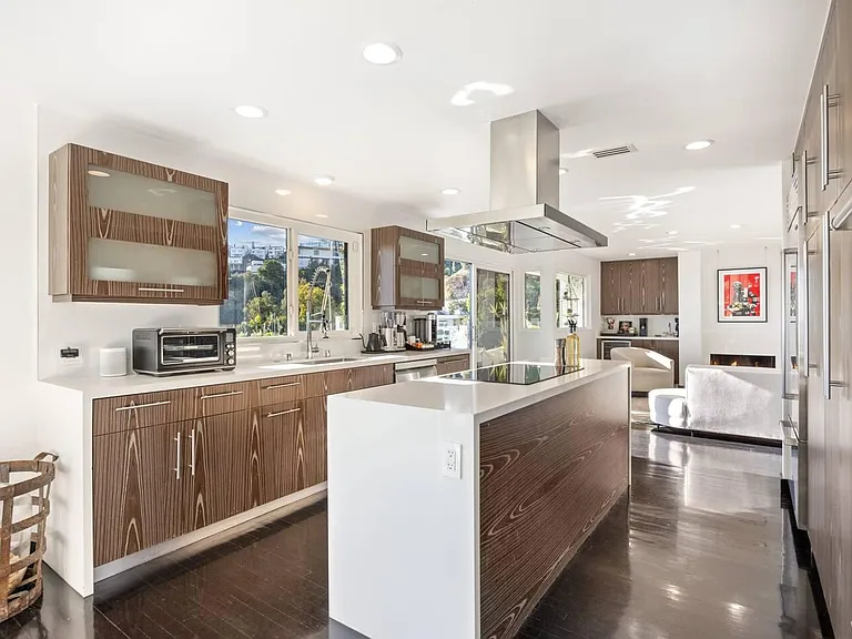 Elevate your culinary experience in our sleek, modern kitchen with high-end Wolf appliances and a massive center island.