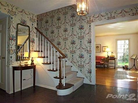 The gracious slate Foyer opens to the Living Room, Kitchen, Family Room and Library.