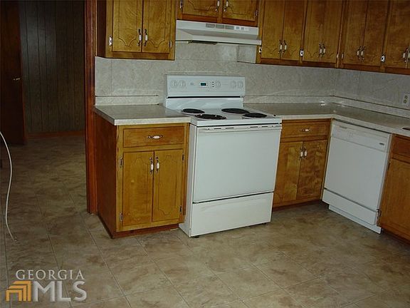 View of Kitchen to Livingroom. Beautiful Cabinets.