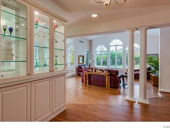 View from the entry foyer showing the open floor plan which overlooks the family room, kitchen and breakfast room