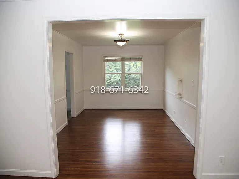 Dining room, with kitchen doorway on the left, and hallway to the right.