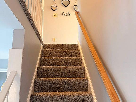 Stairs leading to bedroom in upper level