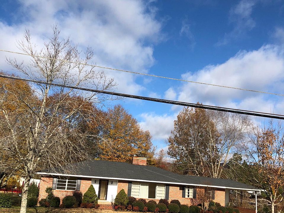 Large brick home with carport. Across st. From JB Pennington High School