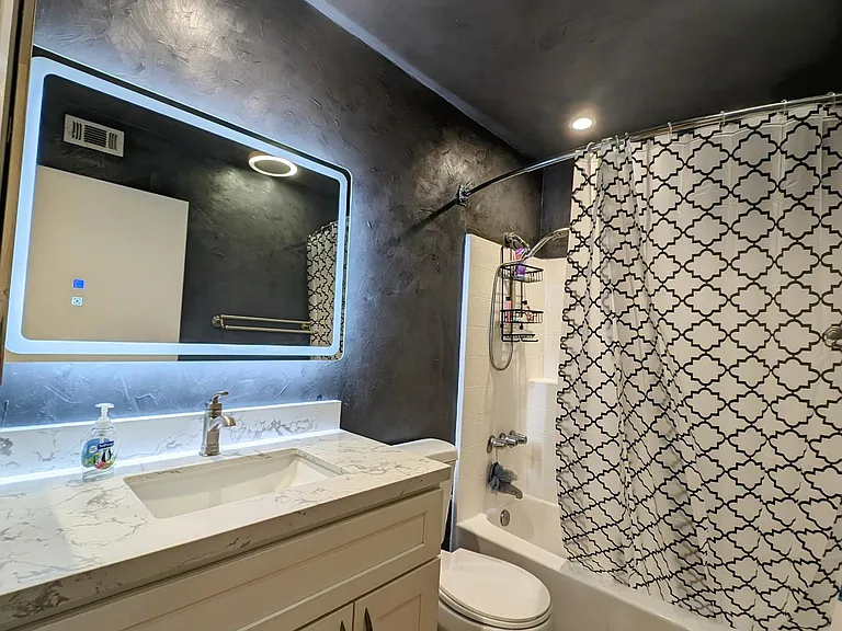 Shared bathroom slightly opened curtains