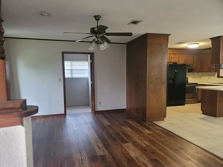 standing at front door. looking at living room. Beyond that is the den. Dining room to the right and kitchen. living room size 12 x 17
