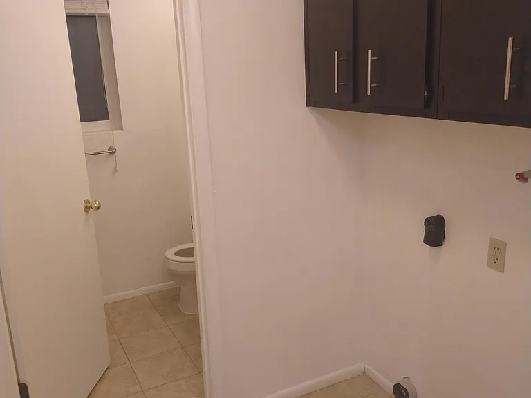 Laundry RooLaundry Room for Washer and electric Dryer hookups, plenty of cabinets, a closet with shelves, and tile flooring for easy cleaning. Bright and well lit!m