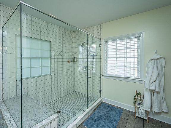 Huge master bathroom shower with natural light and privacy.