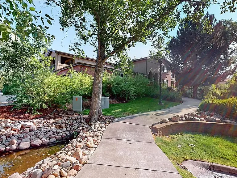 Landscaped area behind the unit visible from the balcony