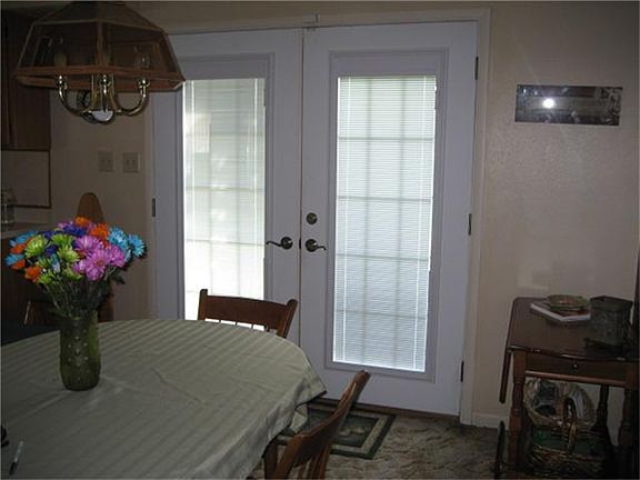 French Doors With Enclosed Blinds on Both Upstairs Balcony and Breakfast Room