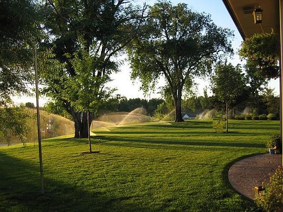 Full sprinkler system on irrigation water to help care for the lush landscapin