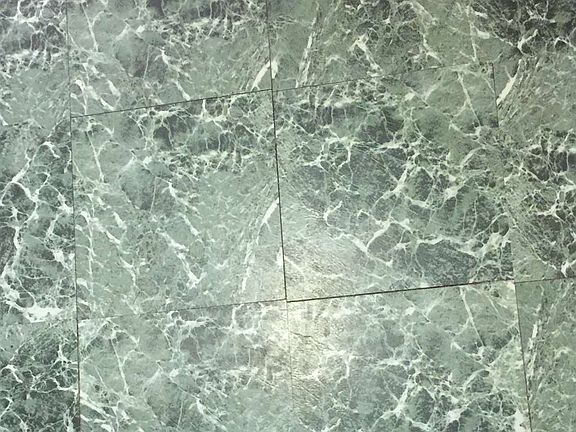 Kitchen floor coordinates with backsplash.