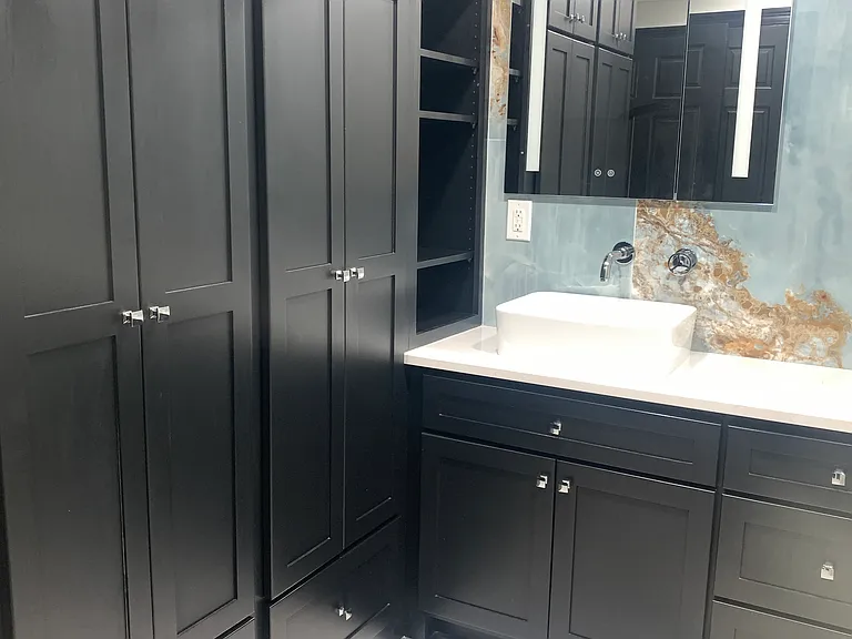 Master bathroom with four closet spaces.