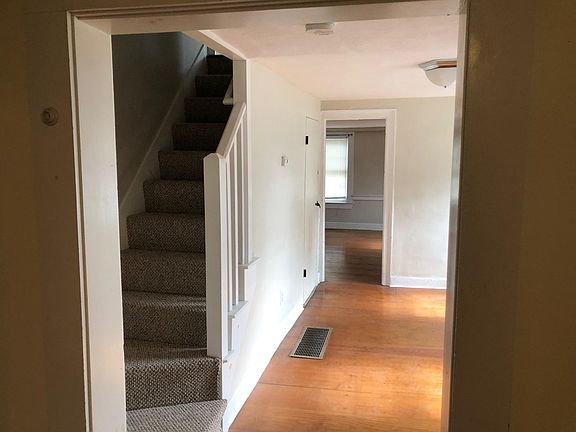 View from kitchen into dining room/office, into living room, and stairs up to bedroom.