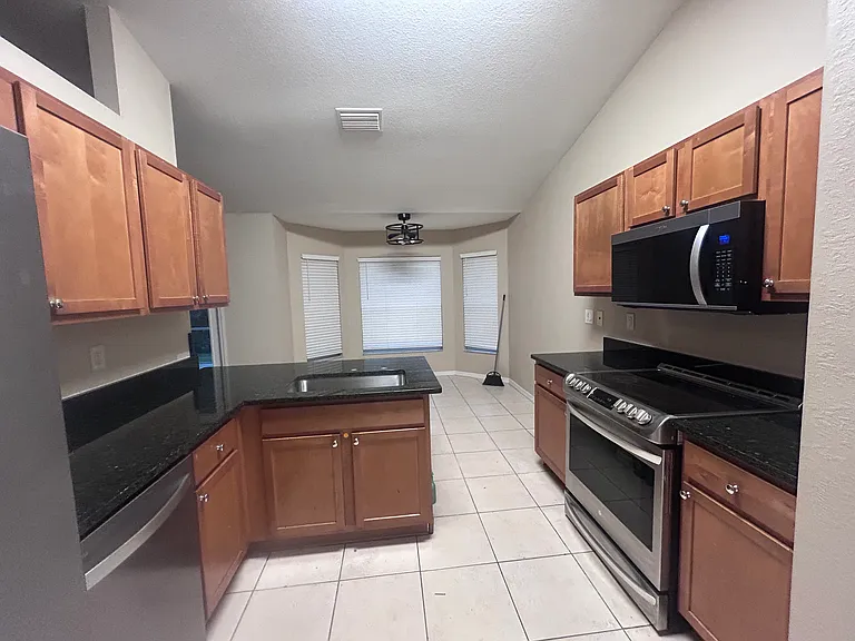 Kitchen with stainless steel appliances in granite countertop