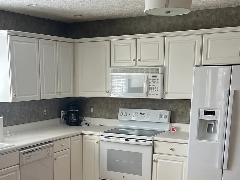 Kitchen includes appliances: glass top range and microwave, refrigerator w/ ice maker, dishwasher