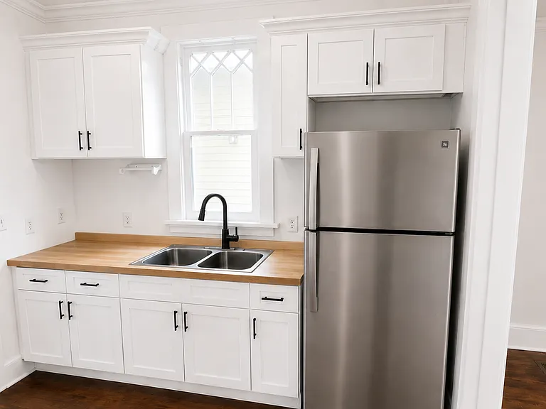 Rendering of newly remodeled kitchen. Kitchen will have a stainless-steel electric range with hood.