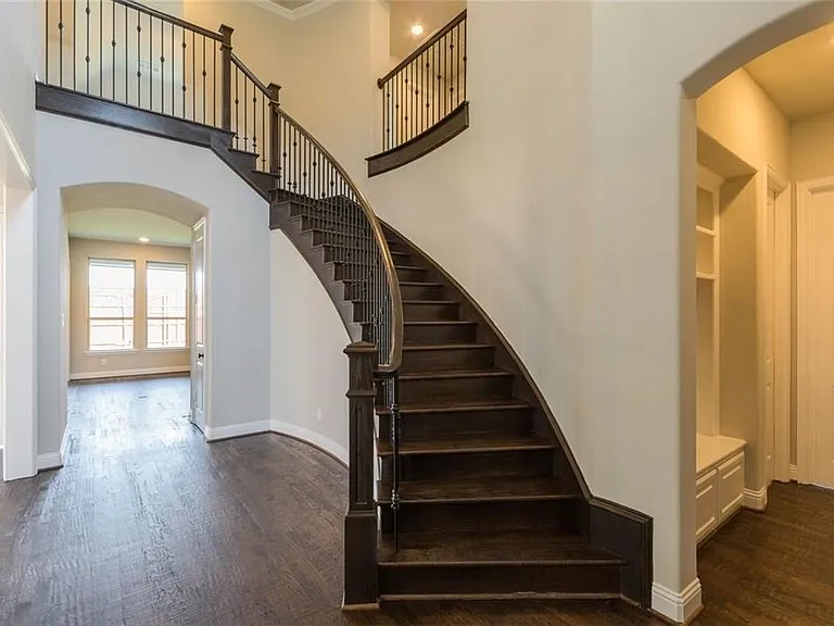Nailed down hard wood floors with a sweeping staircase greets you as you walk into the home.