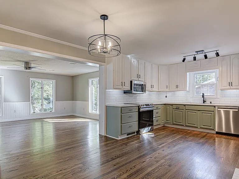 Large kitchen with quartz counter tops, induction cook top, and stainless appliances.