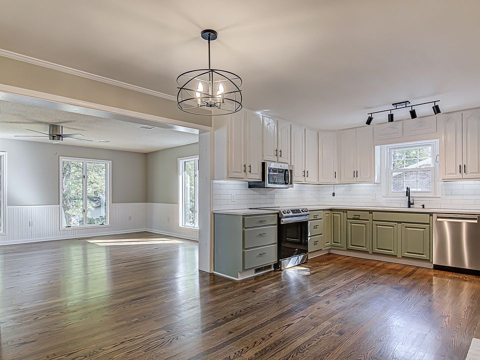 Large kitchen with quartz counter tops, induction cook top, and stainless appliances.