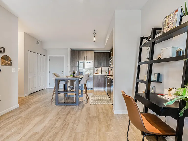 Kitchen Island with Seating and Open Wall Shelving Workspace Nearby