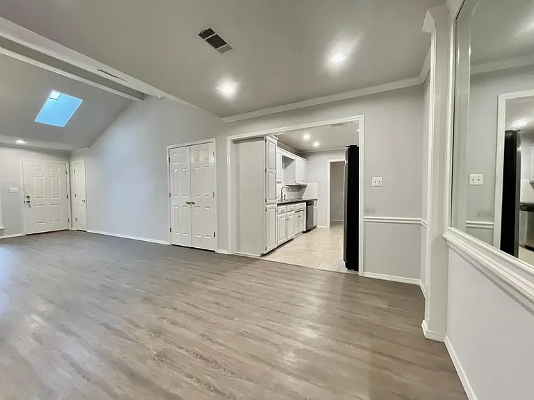 Larger dining area flows into kitchen and living room spaces.