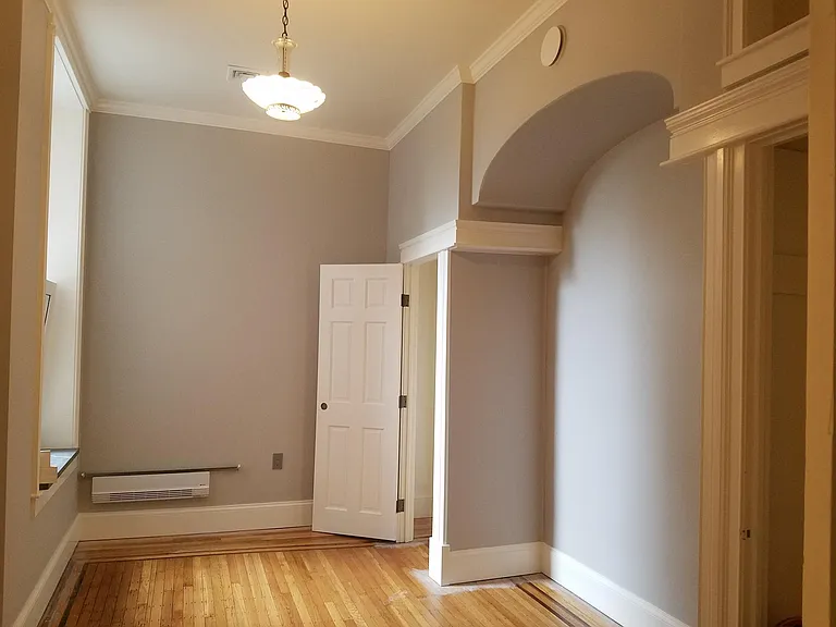 2nd bedroom with bed niche and flanking closets. Restored pendant light, and stone sills throughout.