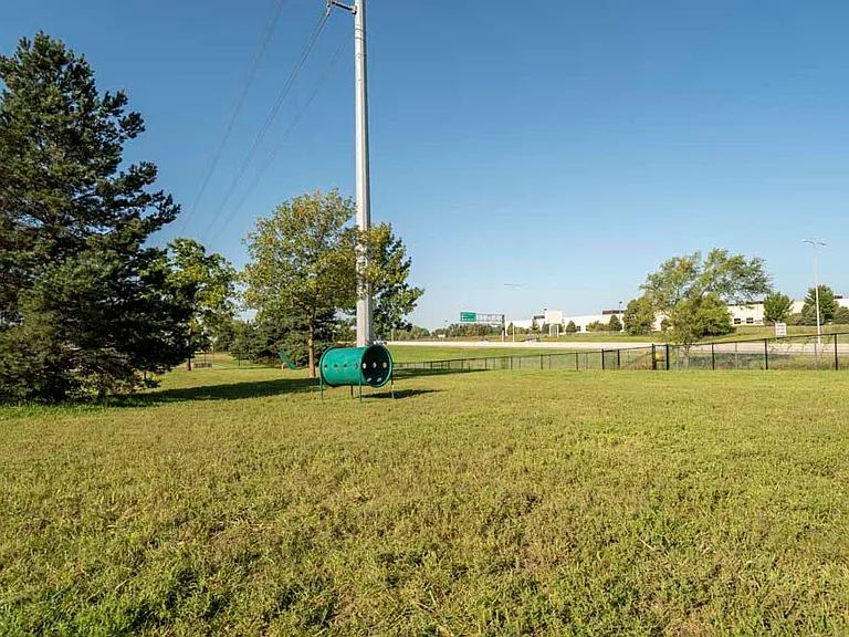 Your furry friends will love the large, private dog park.