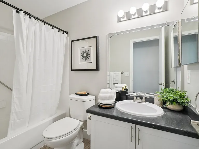 Clean, modern bathrooms feature full shower, toilet, and vanity sink, professionally operated by Highlands Vista Group.