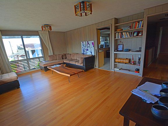 Living room with hard wood floors and built in shelving