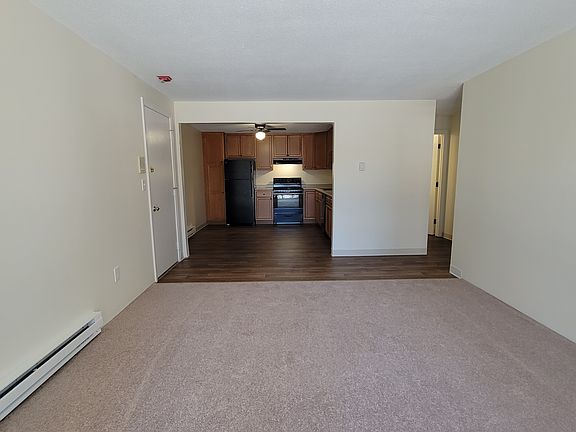 2 bed - Living room looking towards entryway and kitchen.