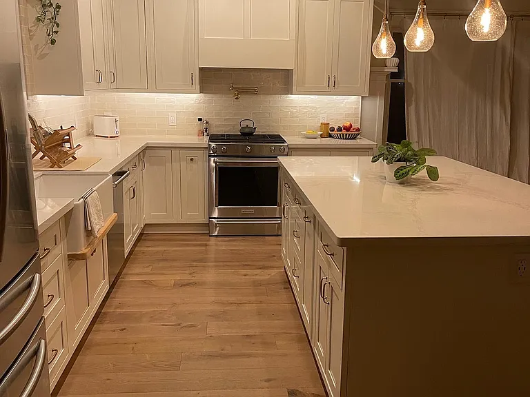 dream kitchen- all white soft close shaker cabinets, stone countertops and 7 foot island. gas range/oven, farmhouse sink with window overlooking the backyard.