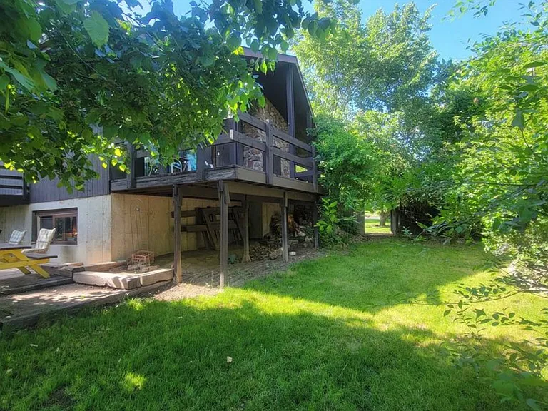 East yard looking at secondary side patio wooden deck off of dining room