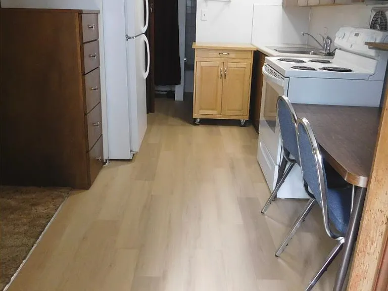 Beautiful new wood look flooring provides a nice contrast to dark cabinetry. Nearly new appliances include a large sized fridge for excellent storage of fresh and frozen foods.