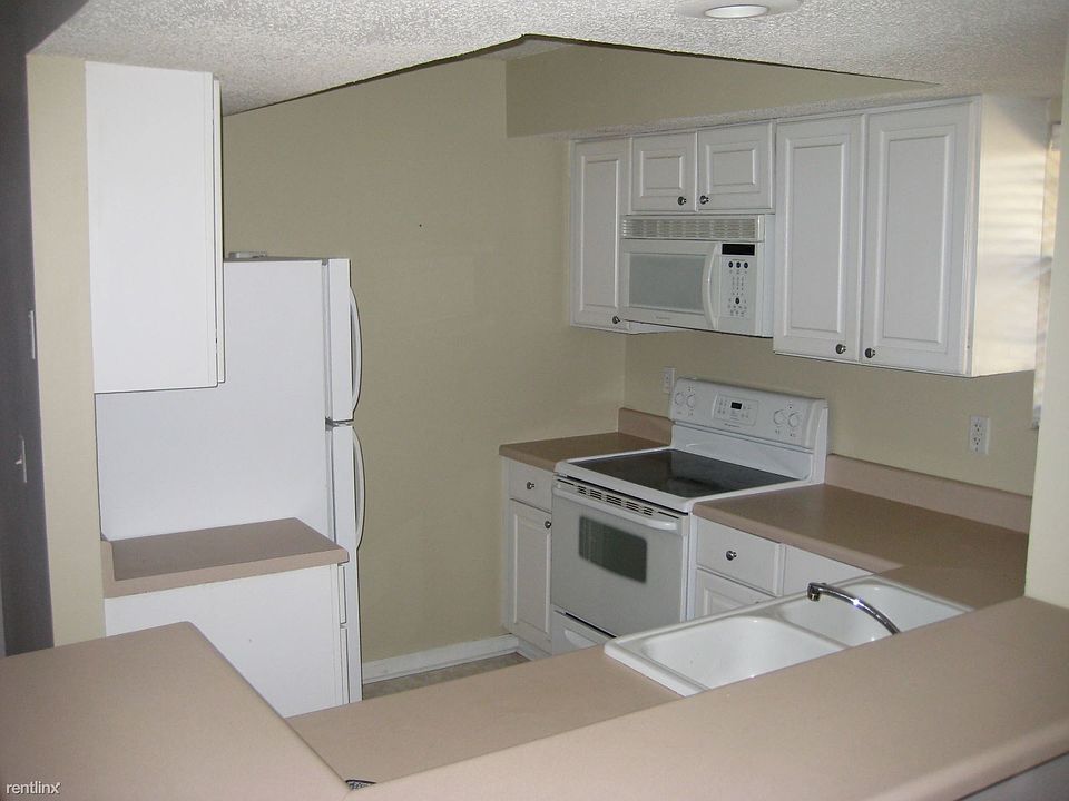 Kitchen opens up to living room and dining area
