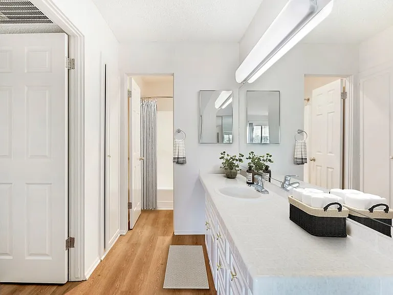 Classic Package II bath with white tile countertops, white cabinetry, and hard surface flooring