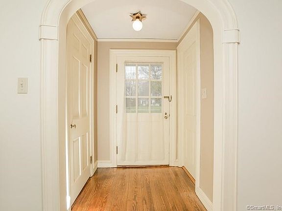 Enter through a welcoming Vestibule, coat closet  on right, that leads to a spacious formal foyer.